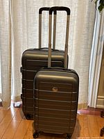 Front view of both suitcases showing size difference and telescopic handles