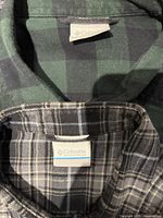 Columbia brand tags on two plaid shirts