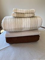 Stacked quilts, shams and bed skirt showing all pieces