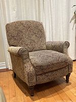 Full view of upholstered paisley push-back recliner chair