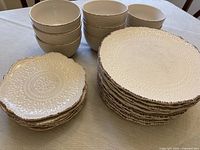 Stack of dinner plates, salad plates and bowls showing pattern and quantity
