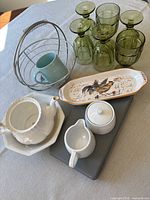 Group shot: basket, mug, six goblets, rooster tray, teapot without lid, sugar bowl, creamer