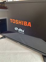 Toshiba TV powered on displaying logo and DTS TruSurround screen