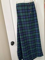 Front view of Black Watch tartan kilt-style skirt showing length and button detail