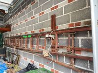 Full view of antique wooden extension ladder mounted on wall