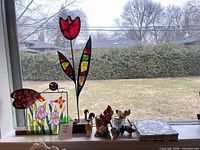 Overall lot showing stained glass pieces, figurines, tiles