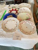 Group of eight assorted decorative dinner plates on table