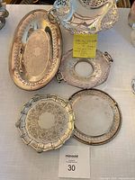 Group view: oval tray, three coasters/salvers and underside of footed bowl
