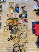 Overall view showing assorted pins, buckles, bangles, corsage