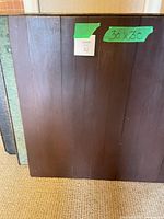 Front view of folded dark brown wood tables