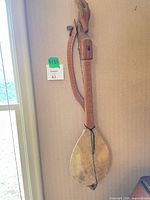 Full view of lute hanging against wall