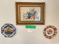 Front view showing framed watercolour and two decorative plates