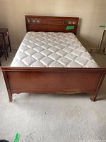 Front view of assembled cherry bed with mattress
