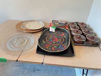full lot: glass plates, metal tray, painted wood tray, ceramic crocks, recipe booklets