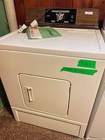 Front view of Kenmore dryer showing door, cabinet and size reference tape