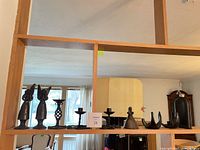 front view of all metal pieces and flask on shelf