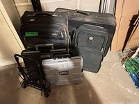 group showing three suitcases, folding dolly, hard plastic case