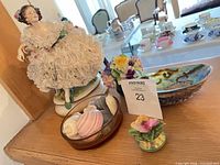 Group shot of figurine, bone china posy, abalone bowl and shell bowl