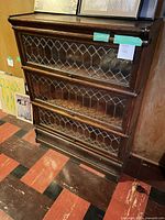 Full view of oak barrister bookcase showing three sections and leaded glass fronts