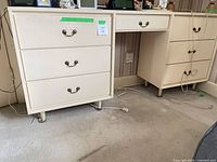 Left pedestal with three drawers, brass bail pulls, center knee space visible