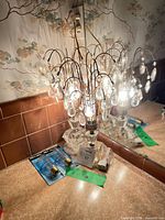 Lamp on vanity showing crystal spray lit, prisms visible