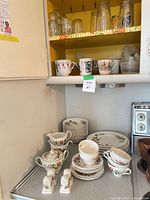 Overall view of stacked floral dinnerware set on counter