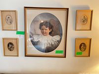 Group shot of all five framed portrait prints on wall