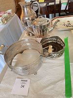 Group shot showing teapot, insulated pitcher, sugar bowl and pierced stand