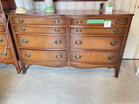 Front view of entire dresser showing eight drawers and overall condition
