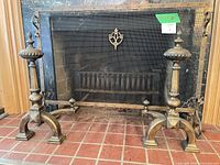 Full view of both andirons in front of fireplace