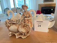 figurine planter with woman and goose beside swan planter