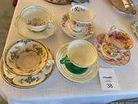 Group shot of all five teacup and saucer sets on table