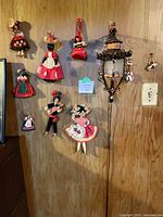 Wall display showing majority of the hanging dolls in various costumes