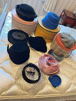 Group shot of all hats and boxes on bed