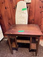 Side table front view with ironing board and headboard behind