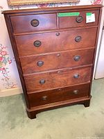 Front view showing full dresser, six drawers, hardware, overall style