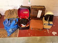 Group shot showing all luggage pieces, helmet, wig and travel pillows