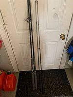 Two Silstar trolling rods leaning against door showing full length