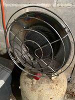 Front view of infrared heater head and wire guard on propane tank