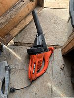 Full view of orange Black & Decker BV2500-CA leaf blower with black nozzle