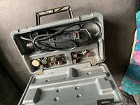 Open case showing rotary tool and accessories