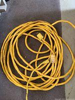 Coiled yellow extension cord