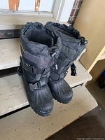 Full view of both boots standing on steps