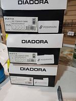 Stacked Diadora boxes showing model, color and size labels