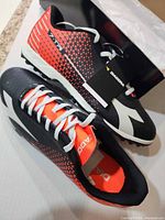 Full view of both shoes showing color scheme, laces, attached tag