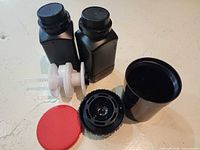 All kit components arranged: tank, lid, cap, spindle with reels, two bottles