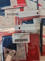Retail packaged Little Britain Ridgetown tube bandanas with $7.95 barcode labels visible