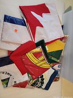 Stack of folded assorted flags showing multiple colours and patterns