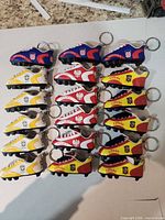 All 18 cleat keychains arranged by country