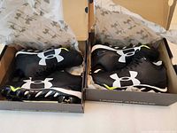 Both pairs in original boxes with tissue paper visible